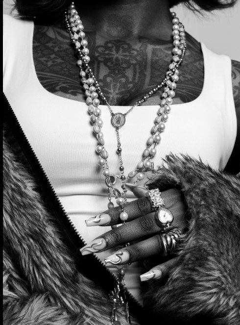 Close-up of pearl necklaces and jeweled hand